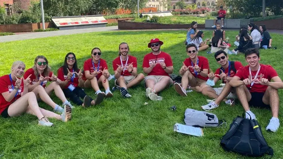 Students sitting outside on grass